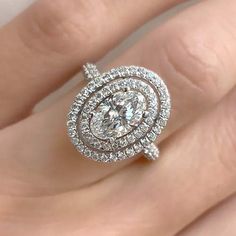 a woman's hand with a diamond ring on it