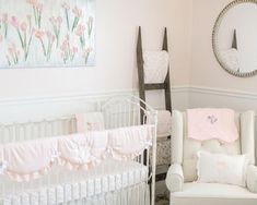 a baby's room is decorated in pink and white