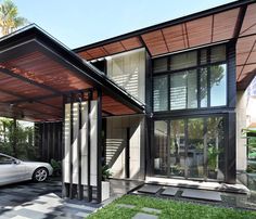 a car is parked in front of a modern house