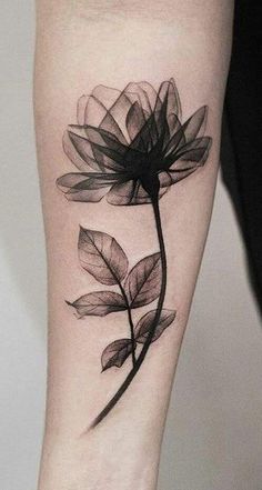 a woman's leg with a flower tattoo on it and an arrow in the middle