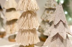 three small christmas trees sitting on top of a table