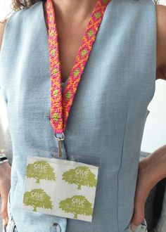 a woman wearing a crocheted lanyard with a tree on it