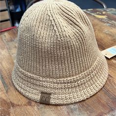 Light Brown C.C Bucket Hat Knit Texture Adjustable Strap For The Perfect Fit Authentic C.C Brand And Quality 100% Cuddly Warm Acrylic Casual Adjustable Soft Knit Hat, Casual Knitted Hat For Everyday, Casual Everyday Knitted Hats, Casual Adjustable Brimmed Beanie, Adjustable Knit Casual Hat, Casual Soft Knit Hat For Everyday Use, Casual Soft Knit Hats For Everyday, Casual Knit Adjustable Hat, Casual Adjustable Knit Hat