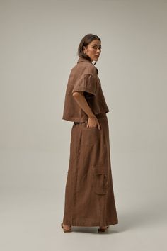 Introducing our Canvas linen skirt, a versatile and effortlessly stylish piece that will elevate your summer wardrobe. Crafted from high-quality linen fabric, it combines comfort and sophistication seamlessly. The side patch cargo pockets add a utilitarian touch while the front opening gives it a relaxed and laid-back vibe. Pair it with a tank top for a breezy and casual look, or opt for a cool t-shirt for a touch of effortless style. For the perfect sophisticated summer ensemble, pair it with t Brown Cargo Skirt With Pockets For Spring, Utility Linen Bottoms With Flap Pockets, Relaxed Summer Skirt With Patch Pockets, Summer Relaxed Skirt With Patch Pockets, Utility Cargo Skirt With Patch Pockets, Linen Maxi Skirt With Pockets For Work, Summer Skirt With Patch Pockets And Relaxed Fit, Summer Workwear Cargo Skirt With Patch Pockets, Summer Cargo Style Skirt For Work