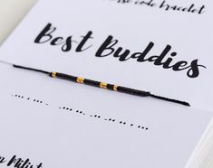 a black and gold beaded bracelet with the words best buddies on it