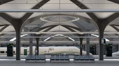 an empty train station with benches and trains