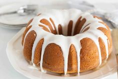 a bundt cake with white icing on a plate