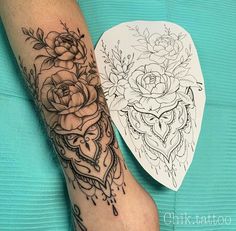 a woman's arm with a tattoo on it and a heart shaped sticker next to it