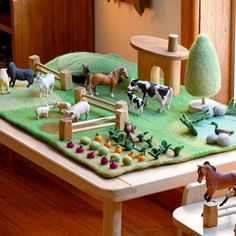 a table with toy farm animals on it