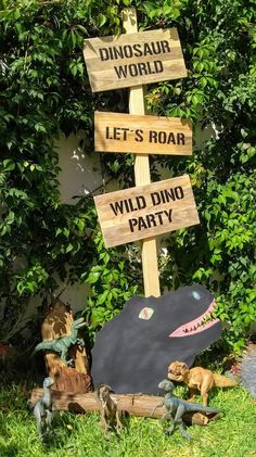 a wooden sign that says dinosaurs world and let's roar, wild dino party