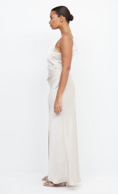 Best selling, high neck maxi dress featuring a flattering tuck detail that cinches the waist and creates a feminine silhouette. Dress is accessed through an invisible side zipper. One Shoulder Maxi Dress, High Neck Maxi Dress, Silhouette Dress, Leg Split, Bec Bridge, Asymmetrical Neckline, Woman Reading, Feminine Silhouette, Boat Neckline