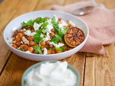 a white bowl filled with food on top of a wooden table