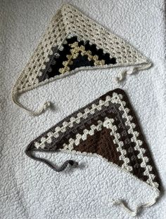 two crocheted triangulars are laying next to each other