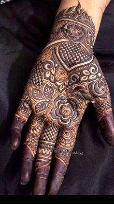 a person's hand with hennap on it, and an intricate design