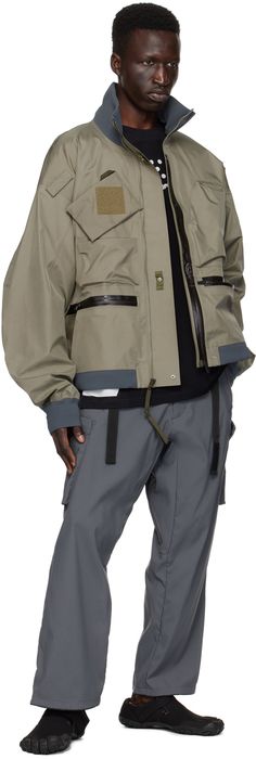 GORE-TEX® 3L nylon ripstop bomber jacket. · Windproof, water-repellent, breathable, and lightweight · GORE-TEX® stretch laminate stand collar, hem, and cuffs · Zip closure · Zip pockets · Velcro tabs at front and sleeves · Concealed bungee-style drawstring at hem · Zip expansion panel at sides seams · Flap pocket at sleeve · Locker loop at back collar · Detachable elasticized shoulder strap at interior · Taped seams · Unlined · Includes studded and logo-printed velcro tape Supplier color: Alpha Functional Nylon Outerwear With Zip Cuffs, Nylon Outerwear With Zip Cuffs For Outdoor Use, Functional Outdoor Outerwear With Zip Cuffs, Techwear Nylon Windbreaker With Zip Cuffs, Functional Streetwear Track Jacket With Zip Cuffs, Techwear Windbreaker With Zip Fly For Outdoor, Outdoor Techwear Windbreaker With Zip Cuffs, Techwear Windbreaker With Zip Cuffs For Outdoor, Velcro Tape