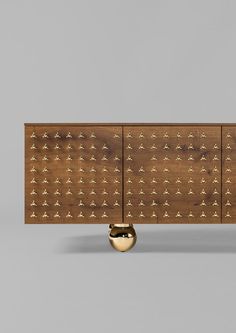 the sideboard is made out of wood and has gold decorations on it