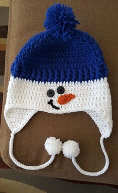 a crocheted hat with a snowman's face on it