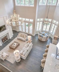 an aerial view of a living room with couches and chandeliers in it