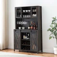 a wooden cabinet with wine glasses and bottles