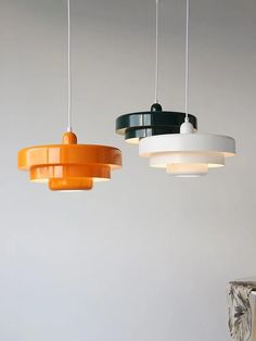 three different colored lights hanging from the ceiling