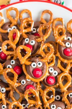 some pretzels with faces and eyes are in a bowl on top of other pretzels