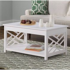 a white coffee table sitting on top of a rug