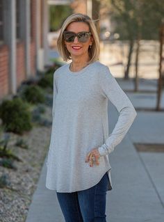 Take a look at our cute Heather Gray Crew Neck Long Sleeve Jersey Top Made out of soft rayon spandex jersey fabric 95% Rayon, 5% Spandex Color: Heather Gray Long Body with sides slightly shorter than front and back Crew neck with 3/4" band Long sleeves Back length from top to bottom 29" Just Style, Long Sleeve Jersey, Jersey Top, Heather Gray, Jersey Fabric, Fashion Blog, Heather Grey, Blouses For Women, Tunic Tops