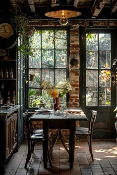 a dining room table and chairs in front of an open window with lots of plants