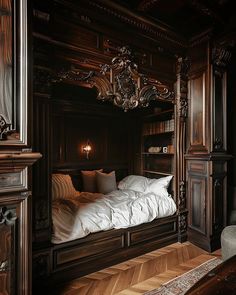 a bed with white sheets and pillows in a room that has wood paneling on the walls