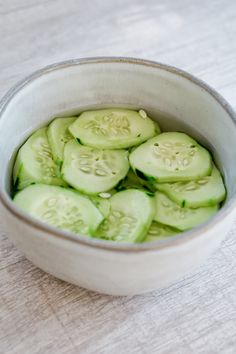 sliced cucumbers in a bowl on a table