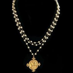 -The Notre Dame de Lourdes Trinity Necklace features three strands of 6mm Freshwater Pearls hand wrapped in 24kt gold dipped chain. It is a medal that was given to Pilgrims to the Holy Waters and apparition site of Lourdes, France. The M in the center honors the Blessed Mother and the 12 Roses surrounding it are symbolic of the Apostles and the 12 Tribes of Israel. Regardless of your faith background, Her presence is a protective and healing balm and a holy medal is a tangible reminder of Her lo The Blessed Mother, Trinity Necklace, Lourdes France, 12 Roses, Healing Balm, 24kt Gold, Blessed Mother, Gold Dipped, Chain Link Bracelet