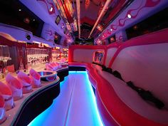 the inside of a bus that has been decorated with pink and blue lights on it