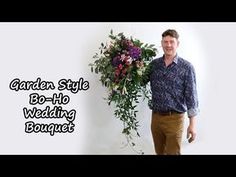 a man standing in front of a white wall with flowers on it and the words garden style bo - fi wedding bouquet