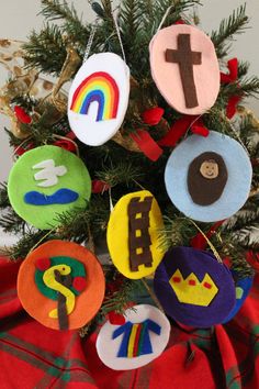 a christmas tree decorated with felt ornaments in the shape of crosses and rainbows on it