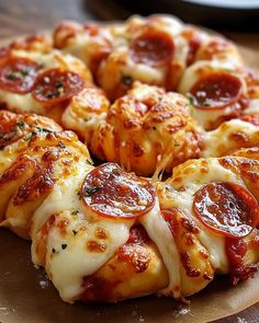 a pizza with cheese and pepperoni is on a wooden platter, ready to be eaten