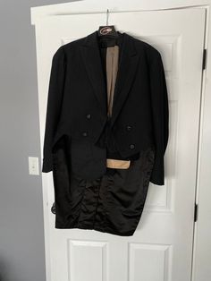 "Incredible full men's tuxedo ensemble from the year 1906. Belonged to a man named Edmund Murphy and dated July 26, 1906 on the interior label (inside pocket). Includes tuxedo pants, tuxedo jacket, vest, black cummerbund, and a tan scarf. Overall great condition! Sturdy and wearable. The only problem spots are that the lining of the cummerbund is cream silk is shattering just a little, the covered buttons are losing their fabric, and there is a group of stain spots and a few small holes on the scarf. Shown in photos.  Men's small/medium Pants: 32\" waist 38\" hips 44.25\" waist to hem 34\" inseam 13\" rise Cummerbund: 48\" length 4\" wide at center, 7\" wide at edges Gray scarf: 62\" long (excluding fringe) 8.5\" wide Vest: 38\" chest 32\" waist 20.5\" shoulder to hem (22\" shoulder to cen Mens Tuxedo, Men's Tuxedo, Tan Scarf, Faux Fur Hooded Coat, Tuxedo Pants, Grey Scarf, Tuxedo Suit, Jacket Vest, Cream Silk