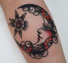 a woman's face on the moon with flowers and clouds around her arm tattoo