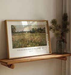 a painting on a shelf next to a potted plant