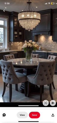 a dining room table with chairs and a chandelier