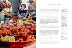 people standing around a table with food on it and in front of them is an article about crawfish boil