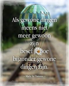 a hot air balloon sitting on top of a train track with a quote above it