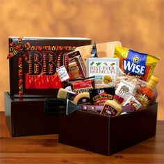 a wooden box filled with lots of different types of food and snacks on top of a table