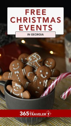 a cup filled with cookies and candy canes on top of a table next to a sign