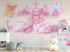 a room with pink clouds and fairy castle wall decals on the walls, along with a stuffed bunny