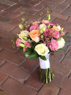 a bouquet of flowers sitting on top of a brick floor