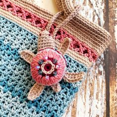 a crocheted bag with a flower on it