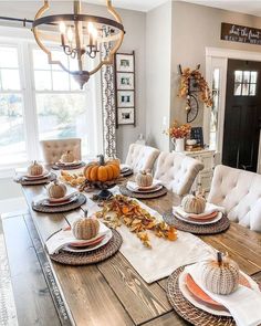 a dining room table set for thanksgiving dinner