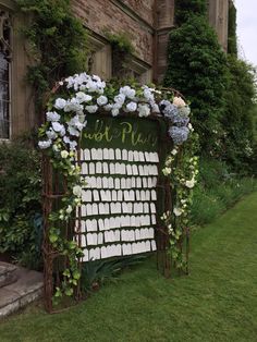 a sign with flowers on it sitting in front of a building that reads just married