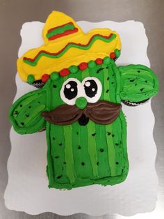 a cake made to look like a cactus wearing a sombrero