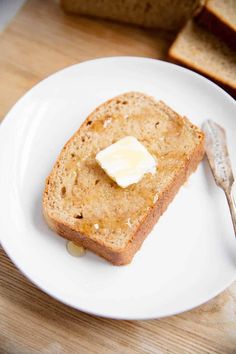 a piece of bread on a plate with butter